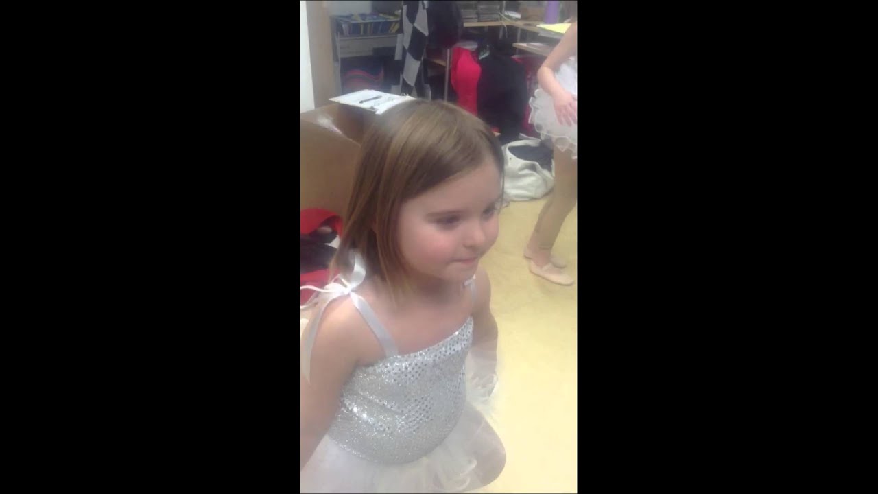 Cute toddlers putting on tiny tutus!