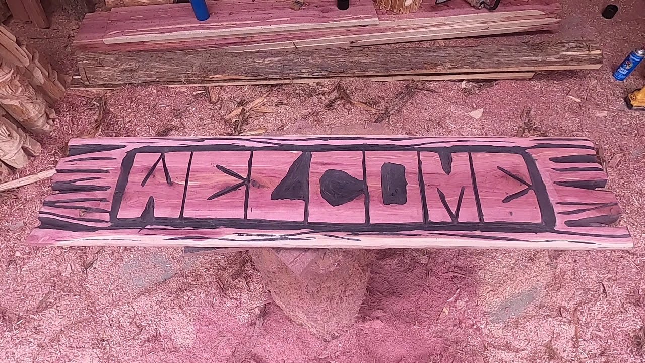 chainsaw carving a rustic welcome sign time lapse