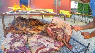 Argentinian Grill Master Roasts Huge Blocks of Bull Meat. Italy Street Food Festival