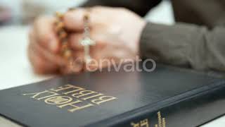 Man Praying Holds in Hand Wooden Rosary with Cross | Stock Footage - Envato elements