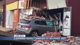 Omaha store owner cleaning up after vehicle damages building