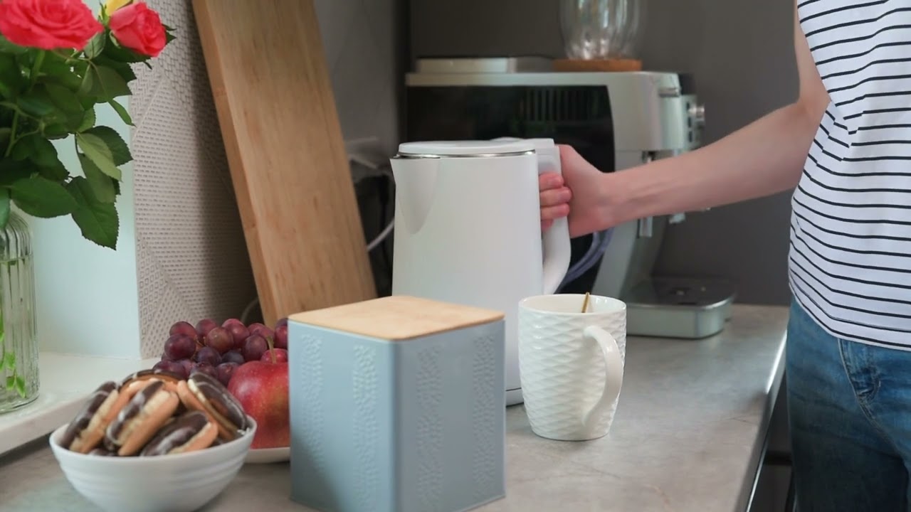 Woman Pouring Water From Kettle for Brewing Tea