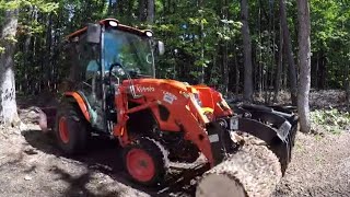 #322 Kubota LX2610 Compact Tractor. Cab tractor deep in the forest. First time. Grapple. outdoors.
