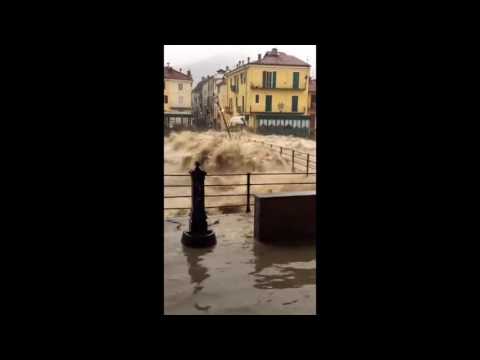 River Swells Dangerously Over Bridge in North Italian Town of Garessio