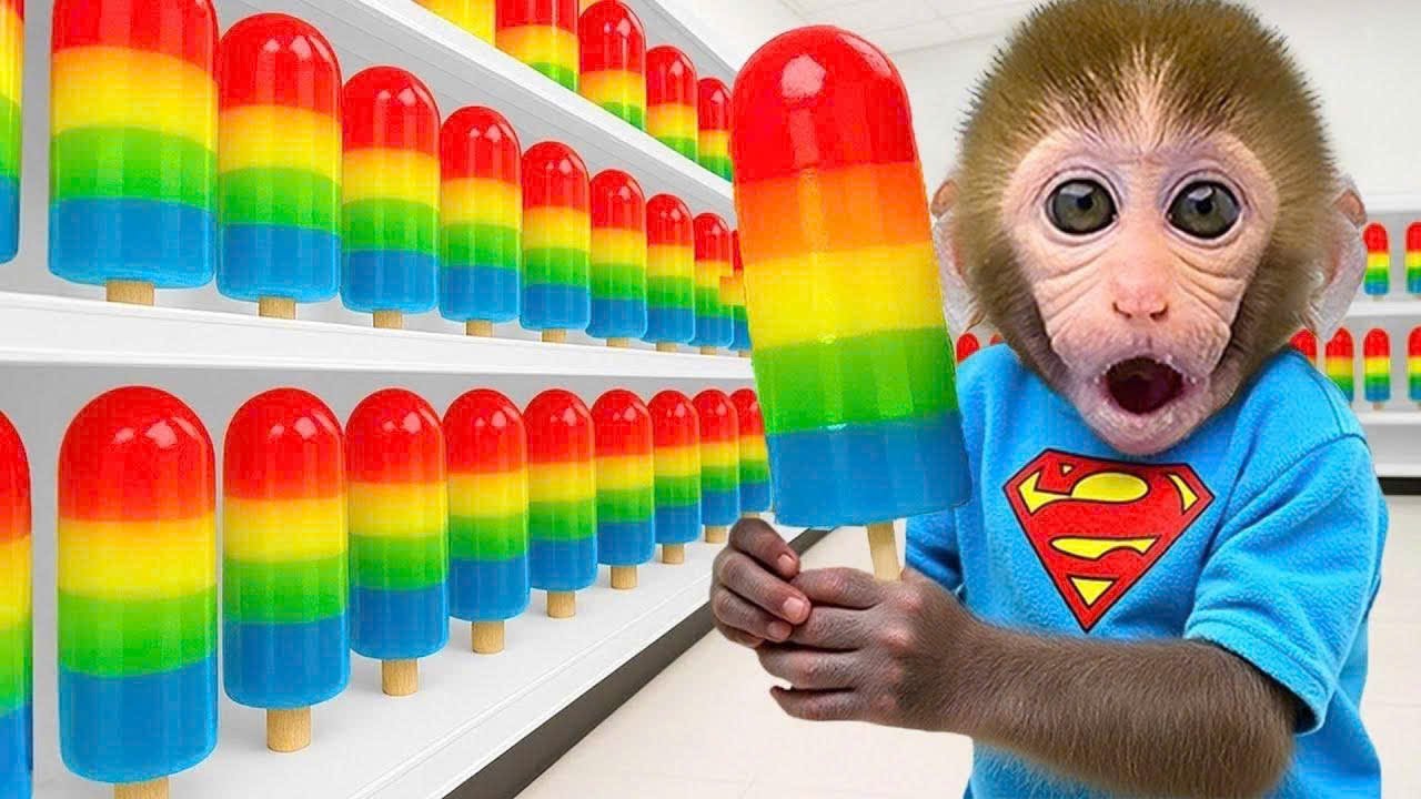 Cute Bon Bon monkey tries to escape from the swarm of bees and enjoys rainbow jelly candies with his