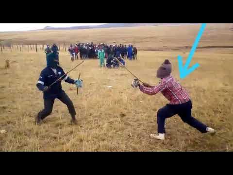 AFRIPICS - Two traditional Xhosa men stick fighting out in the open