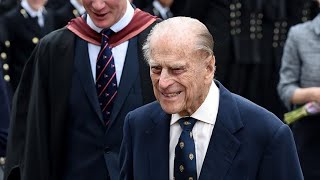 Mourners lay flowers in front of Buckingham Palace after Prince Philip passed away at age 99