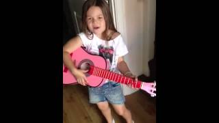 Girl sings and plays guitar