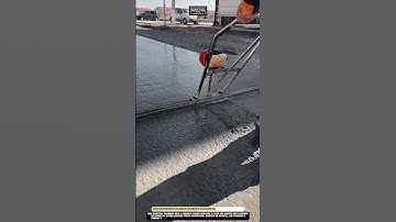 Concrete leveling Worktool smoothing wet pavement with screed vibrator