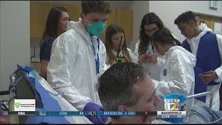 High school students learn about public health through disease outbreak simulation