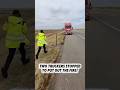 2 truckers stopped on a highway to help another truck driver with burning brakes.