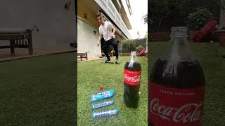 Skateboarder does pop shuv it with Mentos on skateboard that lands in Coca-Cola bottle