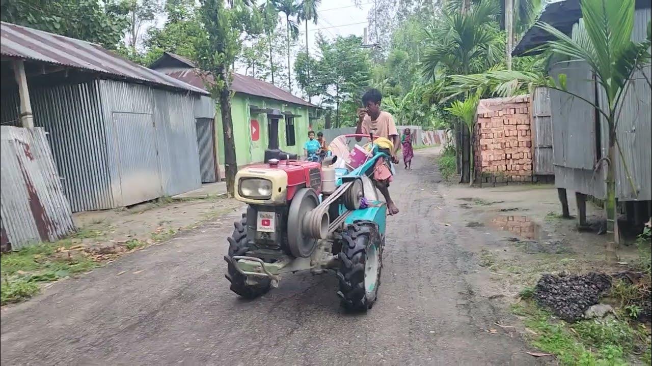 This boy is going to the field with a power tiller machine to cultivate