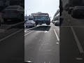 A classic car, a city street, and a sight that defies all logic. What is happening here? Dive into