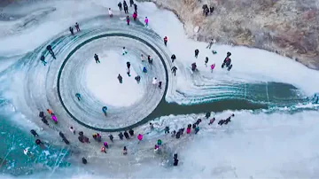 Drone video shows rotating ice circle in frozen river in NE China