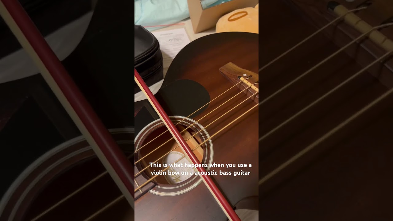 Violin bow on a bass acoustic guitar