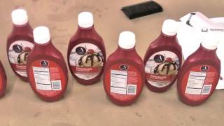 Quadrel Labeling - High Speed Front Back Labeling System for Plastic Syrup Bottles