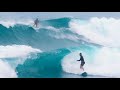 Surfers battle giant waves and intense current