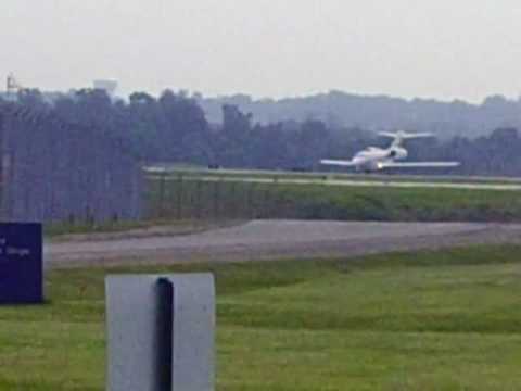 A Cessna Citation X from NetJets depats runway 28R. Shortly after a Northwest Airlines CRJ lands.