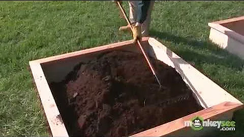 Adding Garden Soil Compost to a Raised Garden Bed