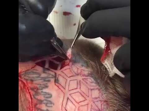 Face scarification tattoo