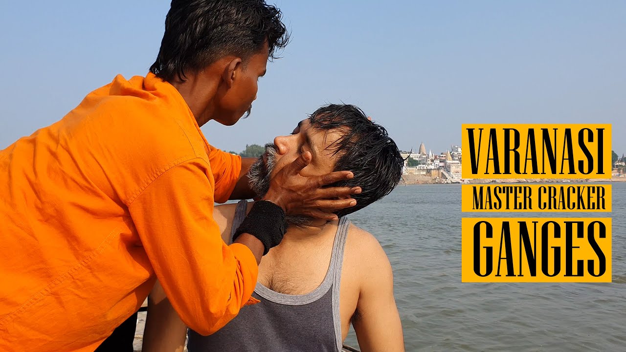 Master Cracker Performing Head Massage on the bank of River Ganga in Varanasi Indian Massage