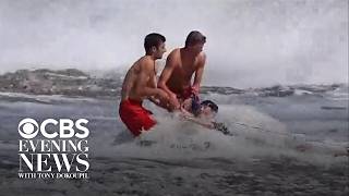 Pair of lifeguards keep young swimmer from being swept out to sea in California