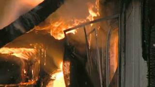 Man hands child off burning second floor, jumps