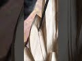Precise carving of intricate details into a large wooden piece using a handheld sharp metal chisel