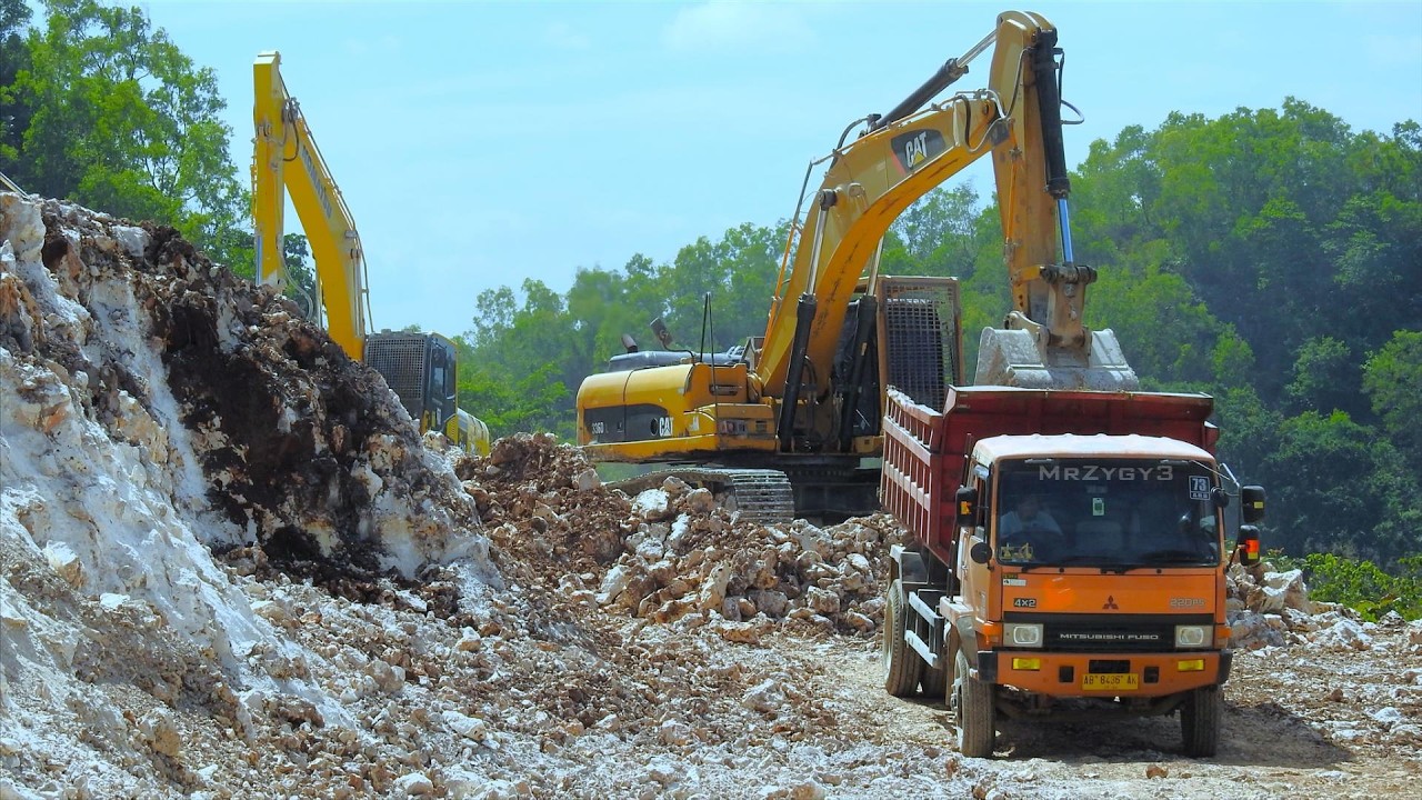 Road Builder Excavator CAT 336D Loading Limestone Dump Trucks