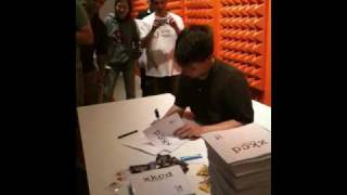 Randall Munroe signing the xkcd book for a robot