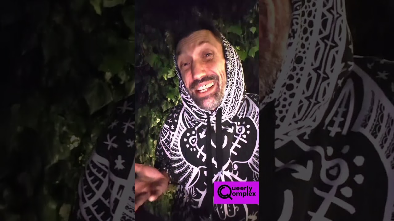Jason wearing a black and white hoodie smiling and looking into the camera