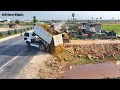 2 project processing filling up the land next to the ring road bulldozer komatsu d31p dump truck