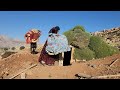 Documentary about the life of a nomadic woman with 3 children  building a wooden hut in the desert