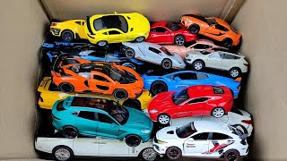 Box full of various miniature cars Peugeot, Volvo, Renault, Hyundai, Pagani, Cadillac One, DHL