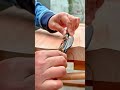 smoothing the edge of a thick wooden board using a manual spokeshave tool for a fine woodworking