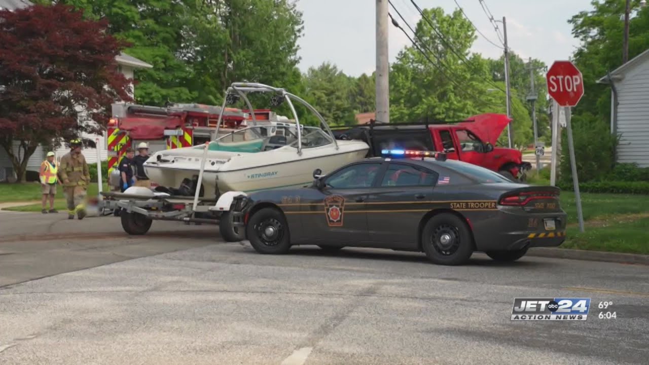 One person extracted from vehicle after car and truck carrying boat ...