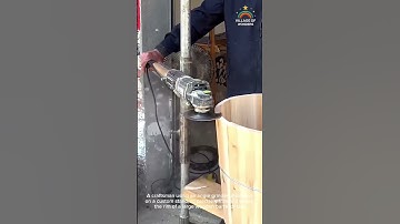 A craftsman using an angle grinder, mounted on a custom stand, to precisely trim and shape the