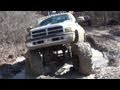 Giant mud trucks poundin the trails at highlifter park