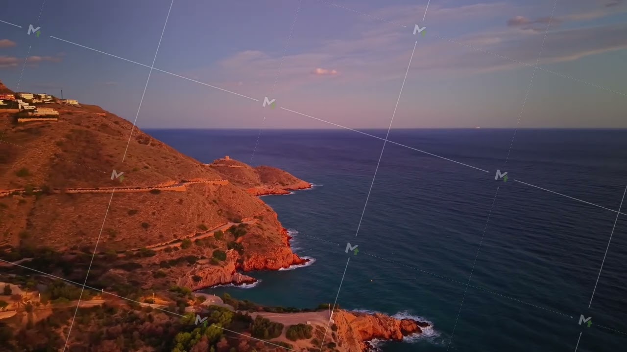 Sunlit Seaside View, Golden Light Bathes Cliffside Villas Near Shimmering Blue Ocean During Sunset