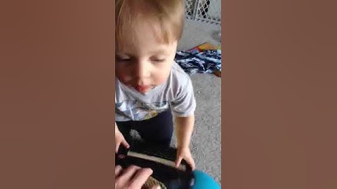 Toddler carrying Vantage Lite AAC device to request a snack
