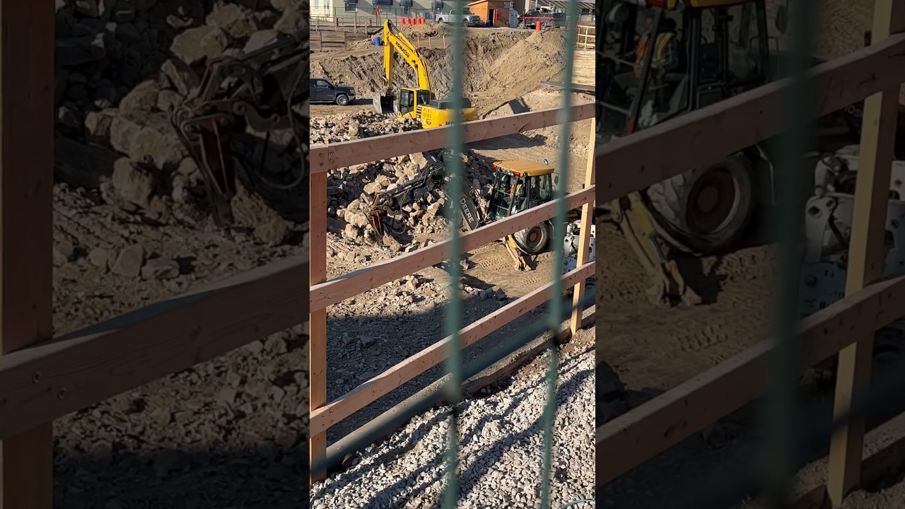 Backhoe jack hammering limestone rock downtown backhoe jackhammer 