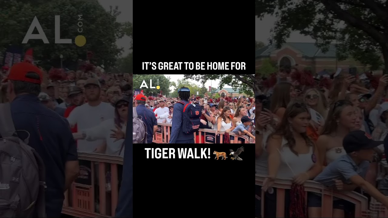 Hugh Freeze carries his granddaughter for the first home Tiger Walk of the season! 