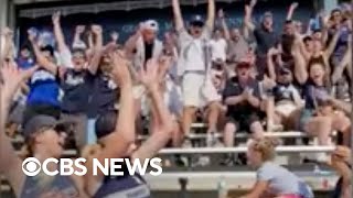 Baseball fans cheer for little girl's' water bottle trick