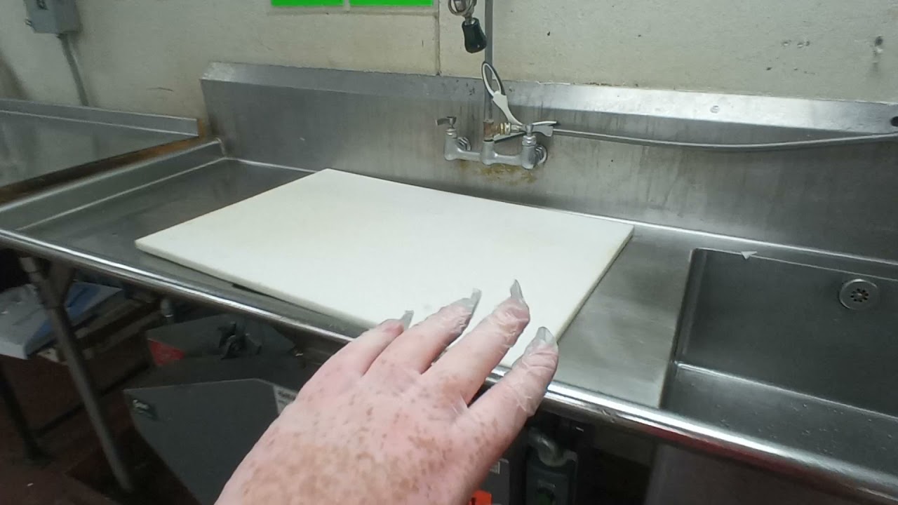 Nasty mold under fresh cut produce cutting board.