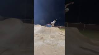 Skateboarder does 180 up ramp at skatepark then falls forward and faceplant