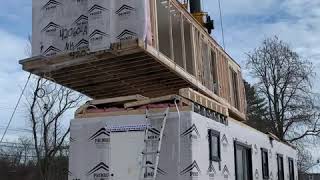 Crane lifting a modular home section