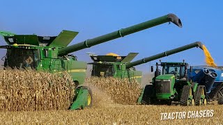 Two John Deere S780 Combines Harvesting Corn with John Deere Tractors