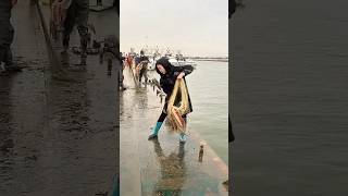 A Woman Showing A Technique For Catching Fish