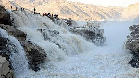 Icicles formed over running waterfall in N. China